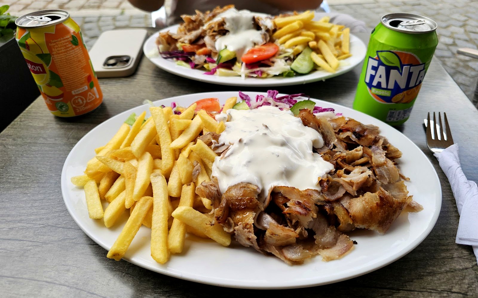 Generous doner plate with fries, fresh salad and garlic-yoghurt sauce at Berfin Grill